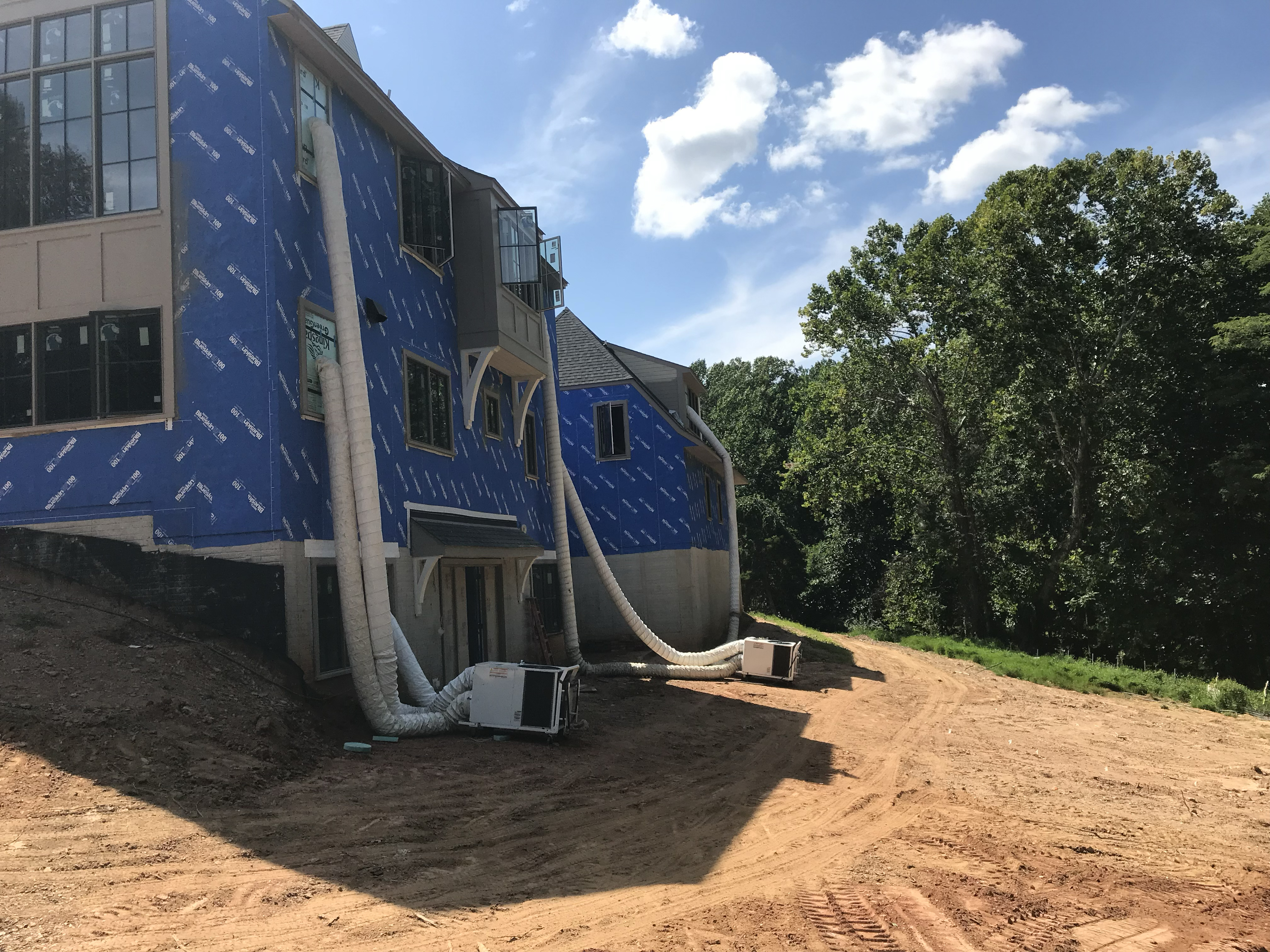 Portable air conditioners installed outside of a building under construction.