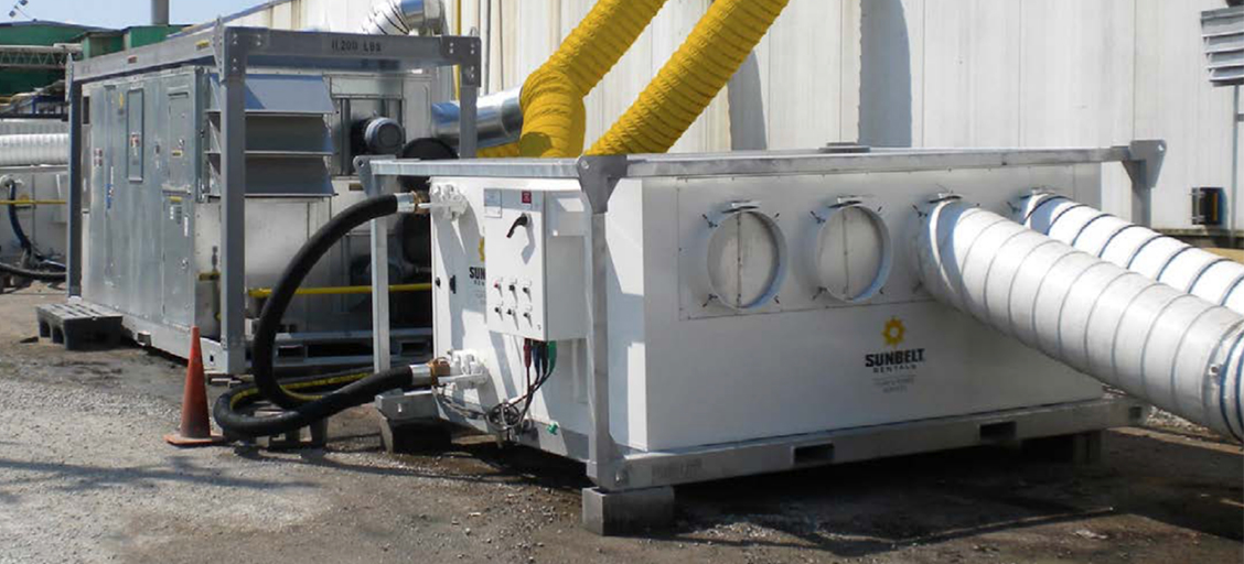 A Sunbelt Rentals air handling unit positioned outside of an industrial facility.